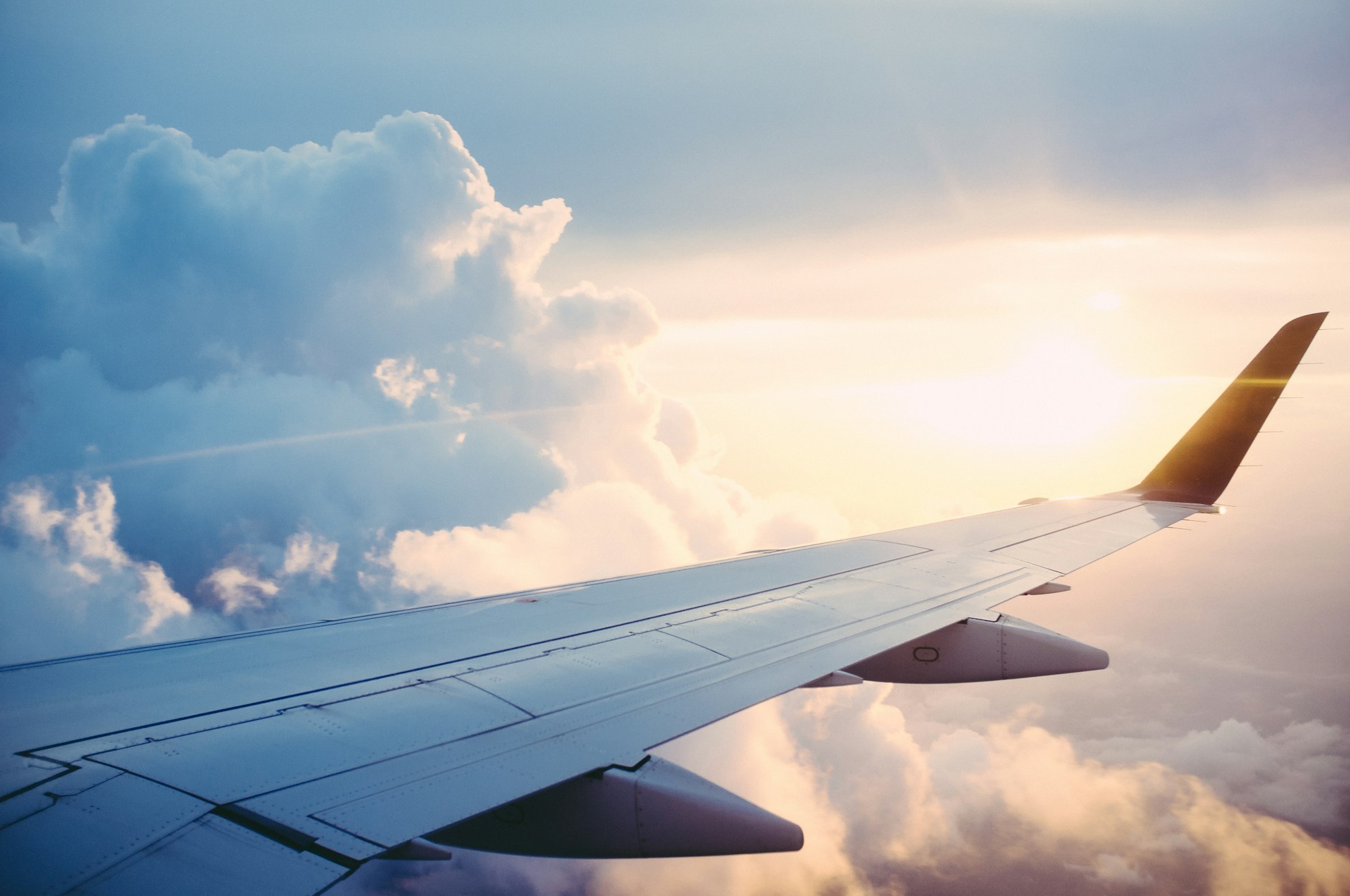 A plane draws a line and the day feels bigger.